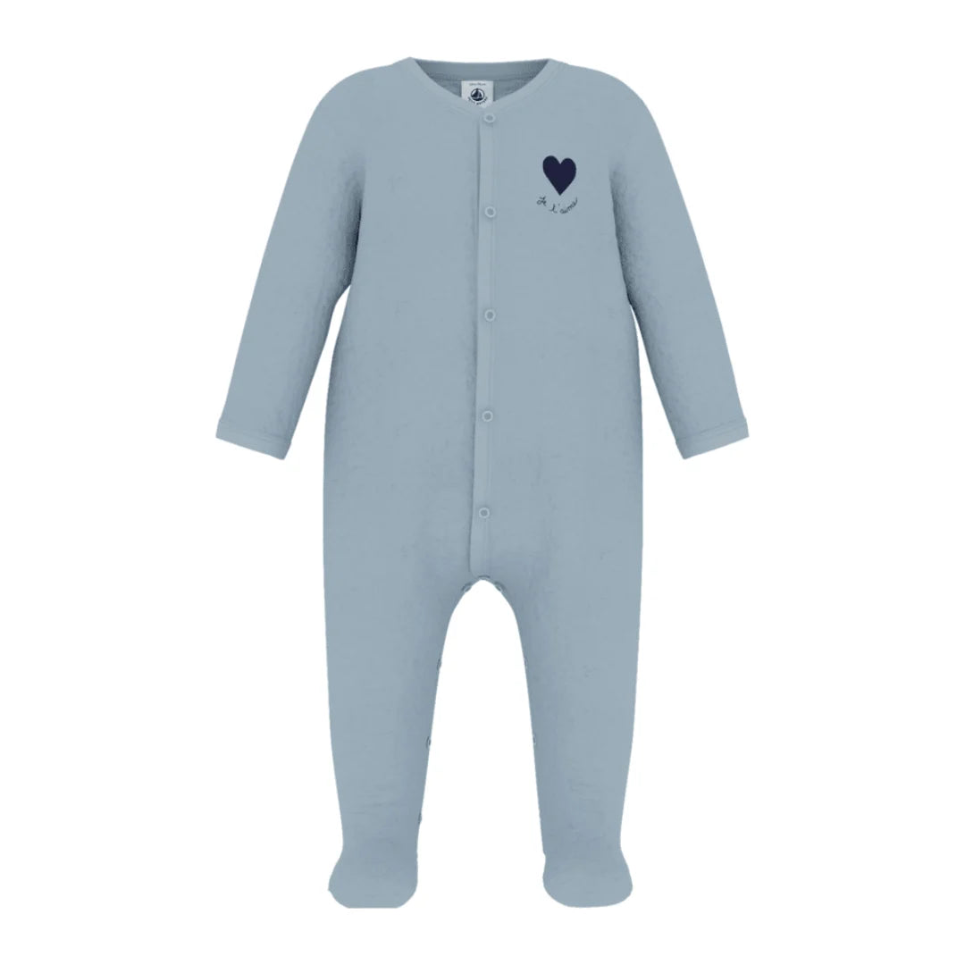 A breathtaking Petit Bateau velour footie featuring an immaculate blue palette, delicate heart detail, and convenient front snap closures.