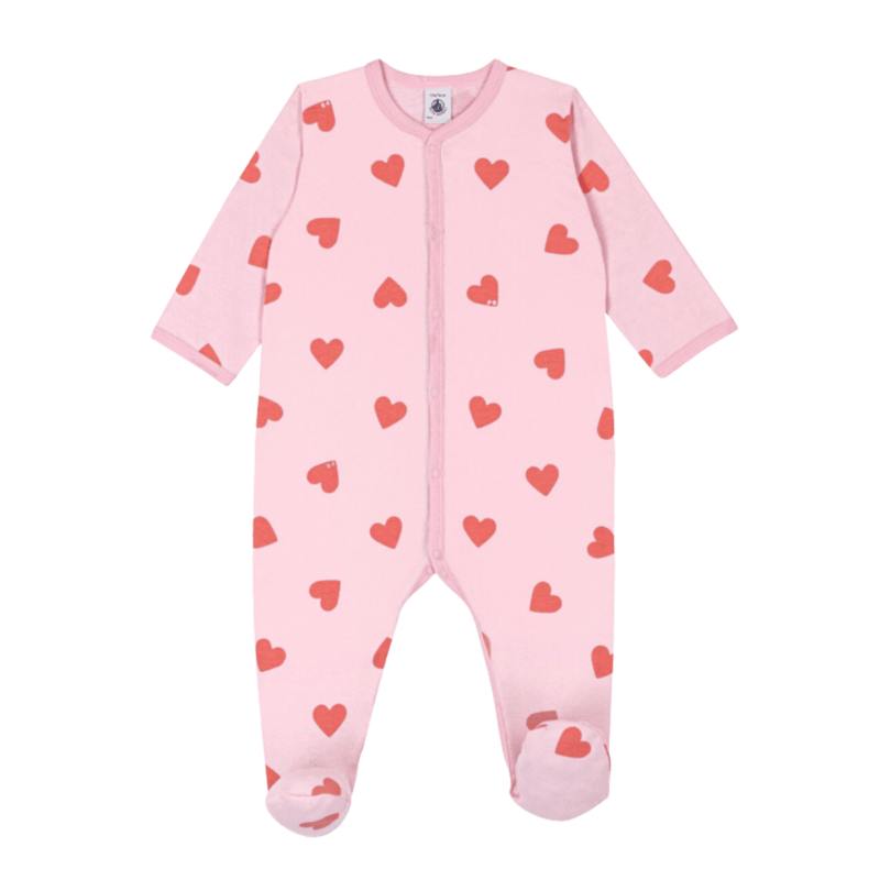 A front view of the Petit Bateau footie featuring a classic heart print and front snaps.