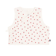 A breathtaking Petit Bateau baby vest featuring an immaculate white backdrop and a charming red heart print