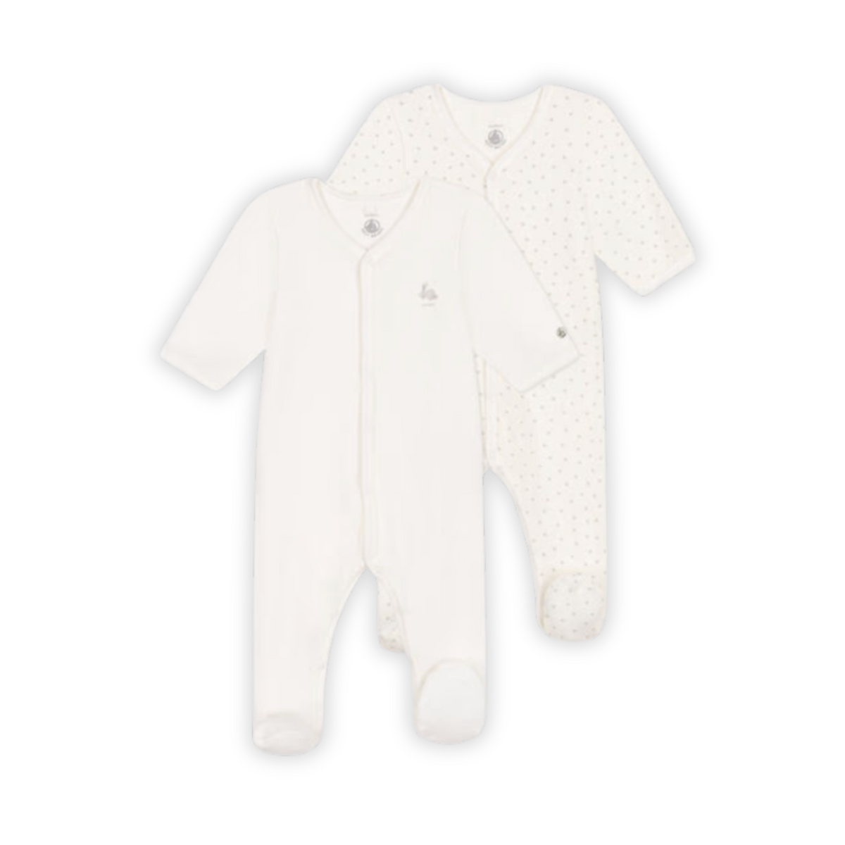 A flat-lay view of the Petit Bateau 2-pack velour baby pajamas in gentle neutral tones.