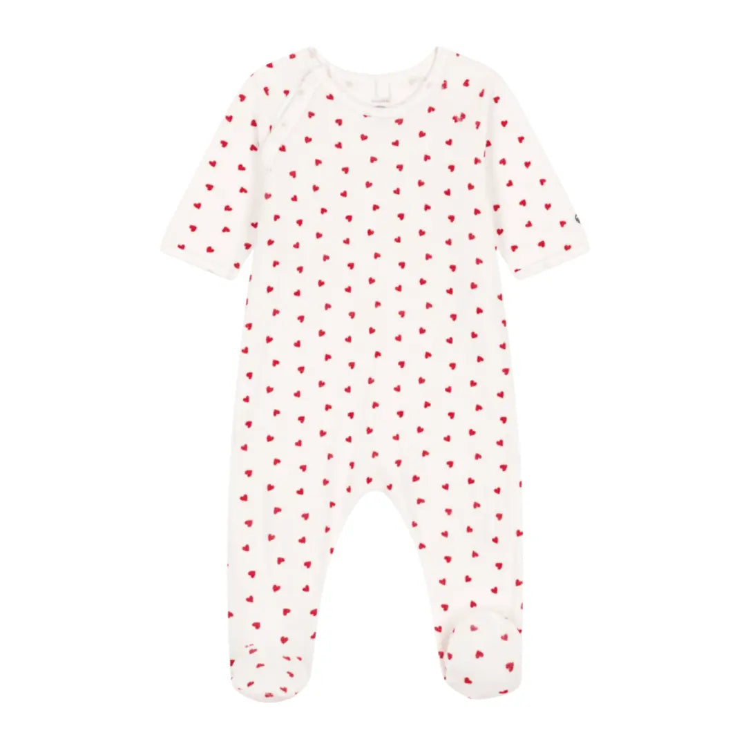 A breathtaking Petit Bateau Velour Footie featuring a pristine white palette, a delicate red heart print, and seamless side snap closures.