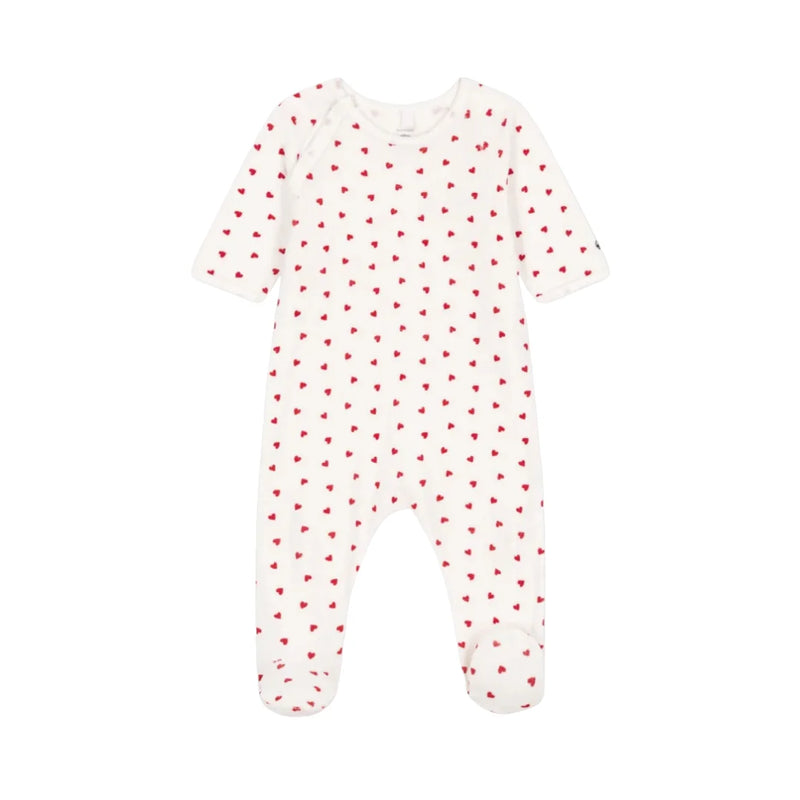 A front view of the soft white Petit Bateau velour footie with red heart prints and side snaps.