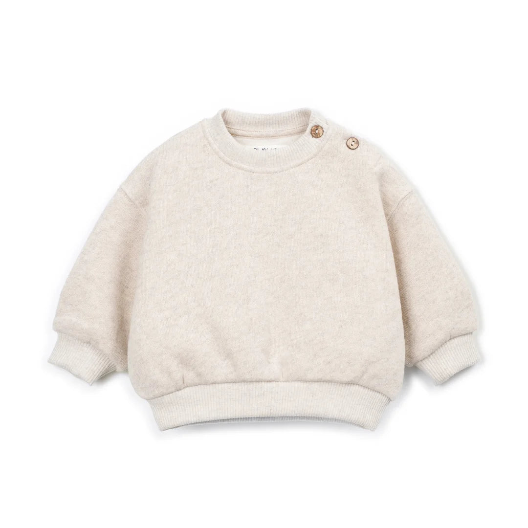 A front view of the Play Up fleece sweater in beige.