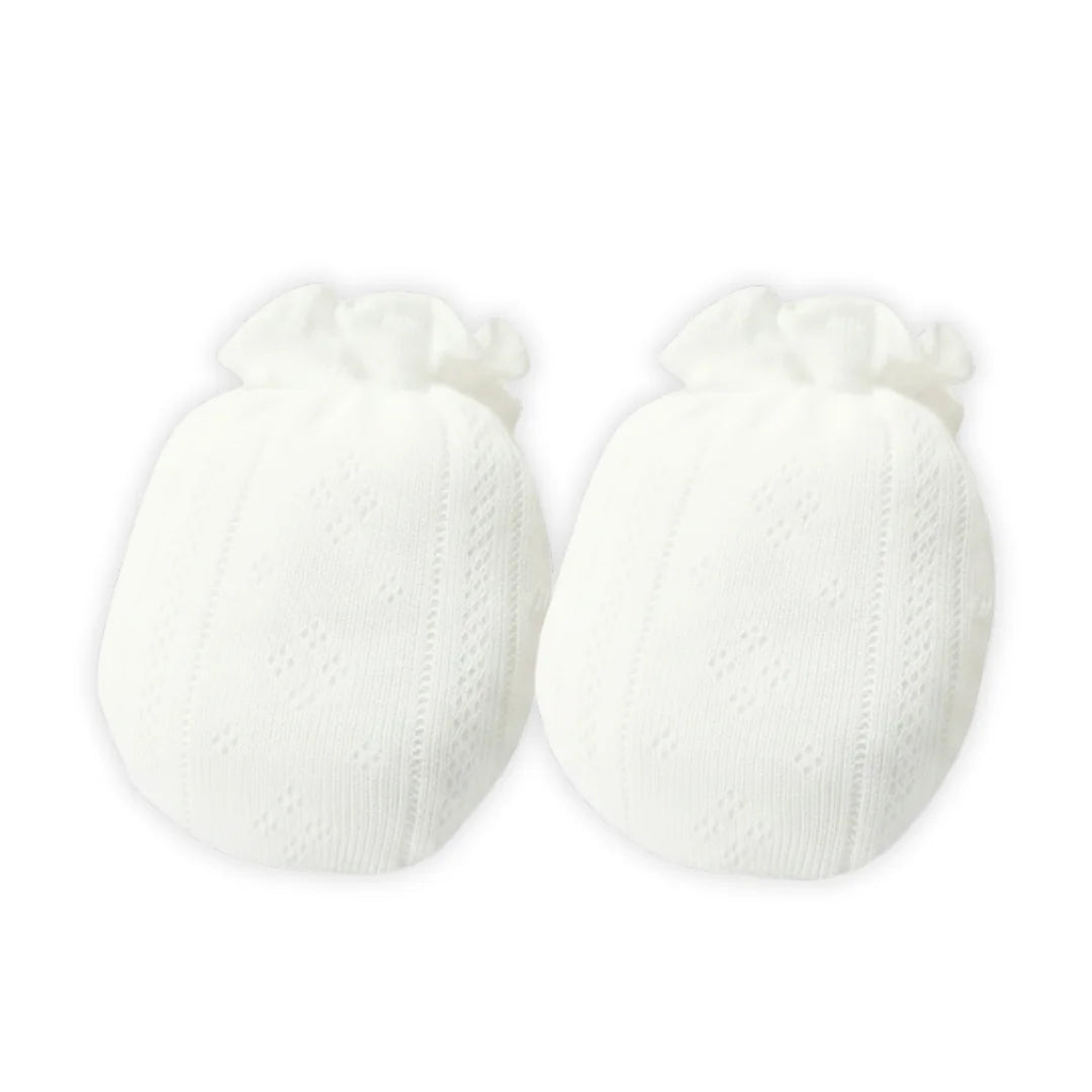 A pair of delicate white pointelle knit cotton mittens for newborns.
