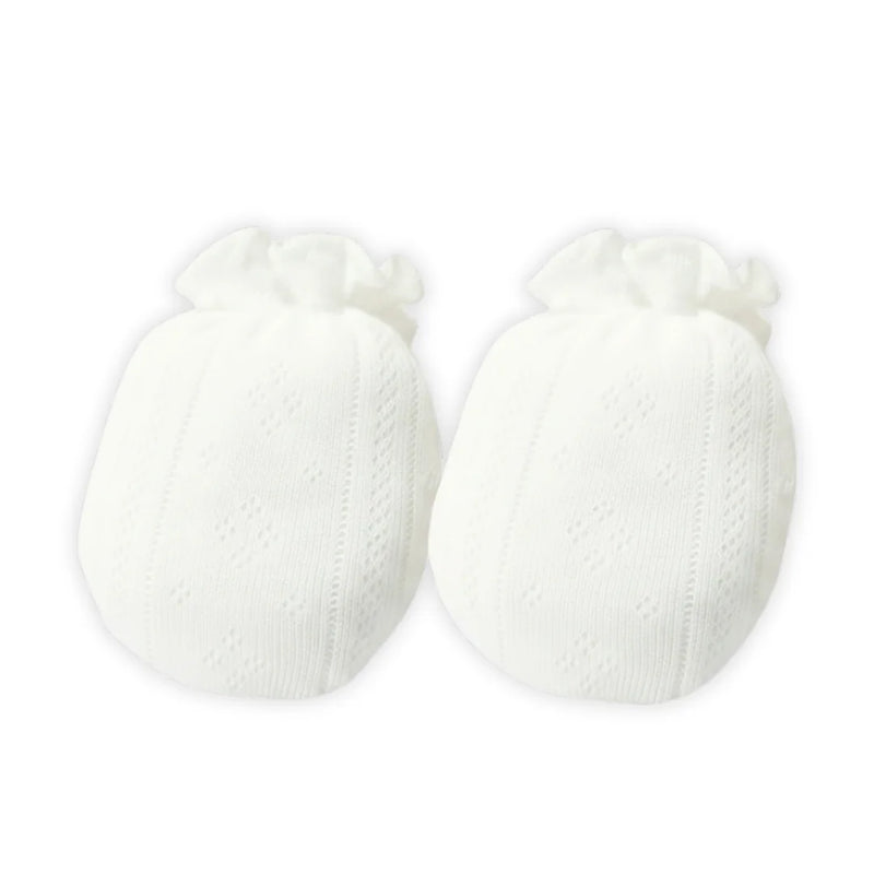 A pair of delicate white pointelle knit cotton mittens for newborns.