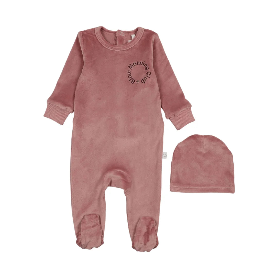 A front view of the Pouf pink velour baby footie with signature logo embroidery.