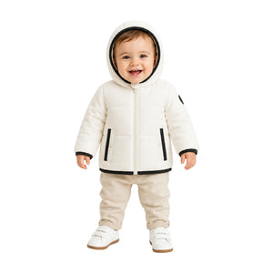 A toddler styled in the Pramie black binding jacket during an outdoor outing.