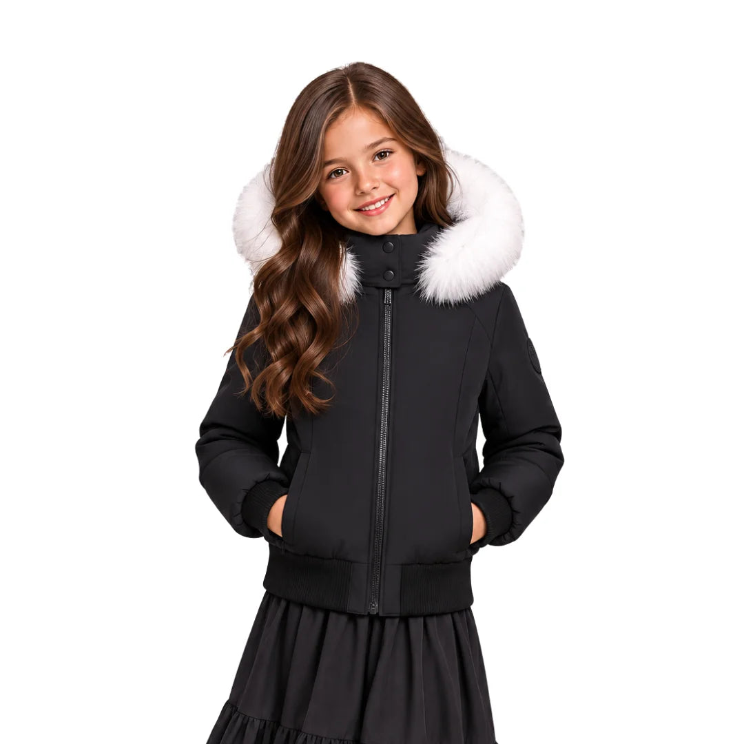 A youth styled in the Pramie white fur bomber jacket during a winter day out.