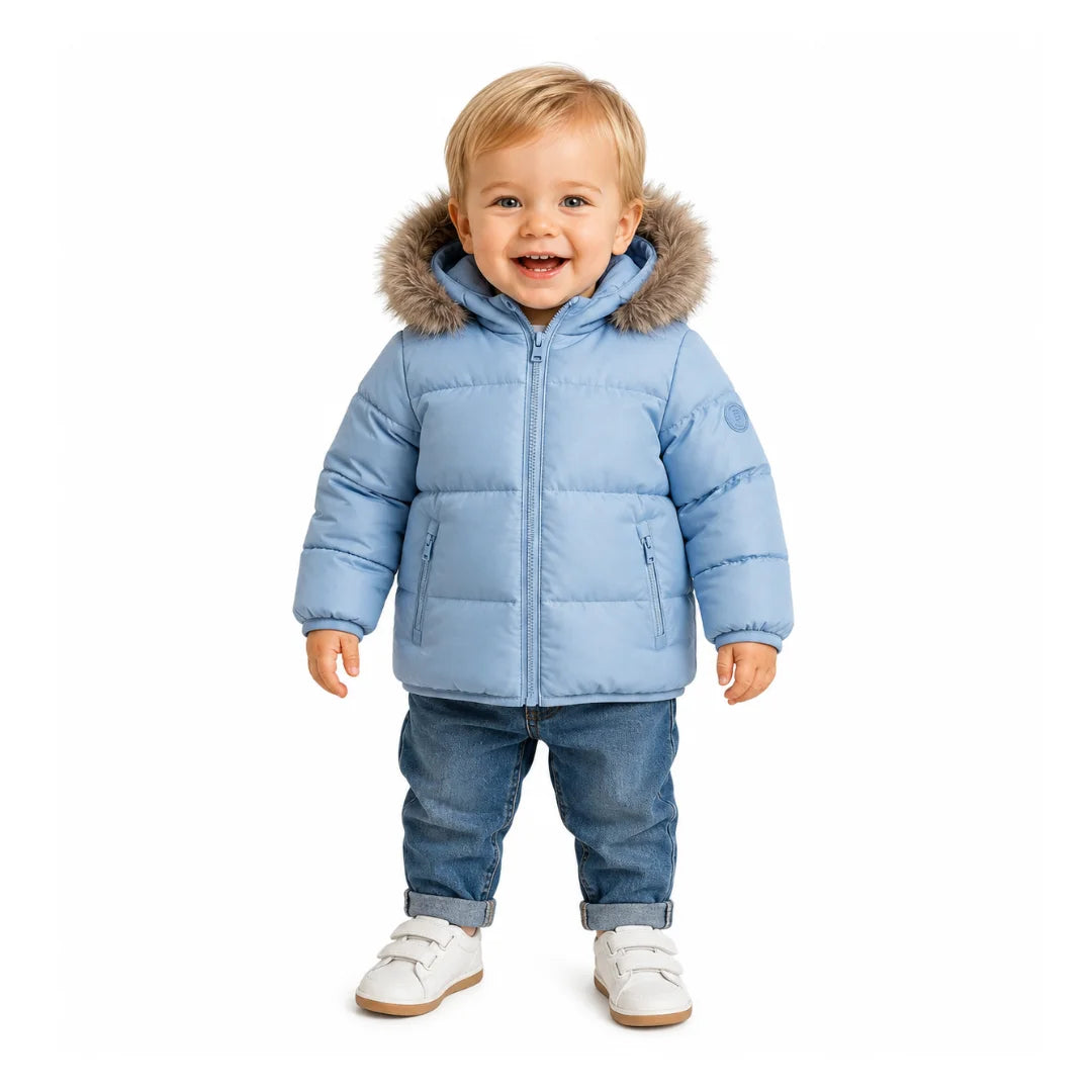 A toddler styled in the Pramie blue contrast coat during an outdoor autumn outing.
