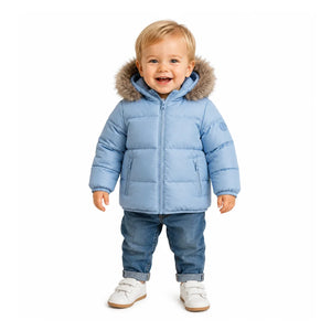 A toddler styled in the Pramie blue contrast coat during an outdoor autumn outing.