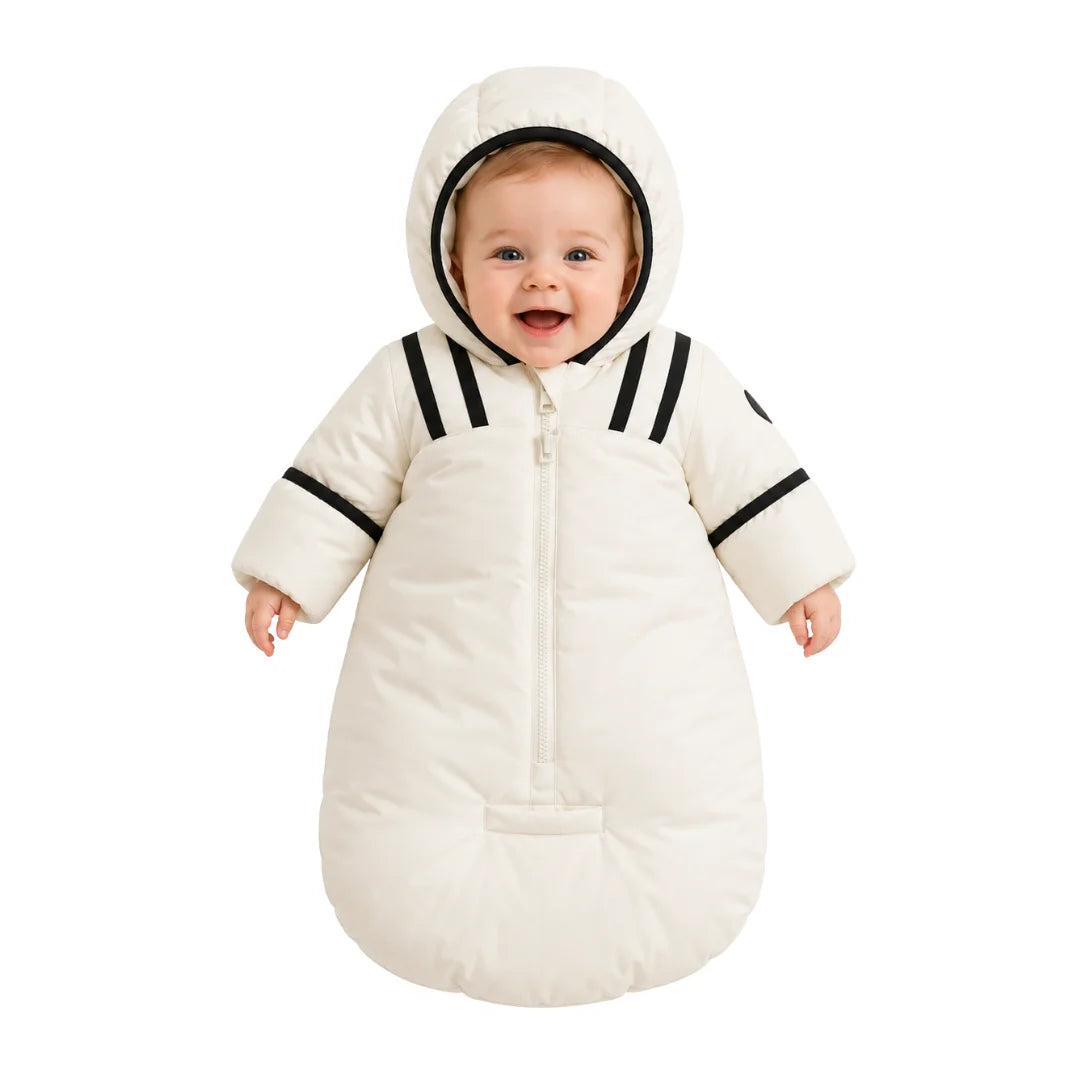 An infant resting comfortably in the Pramie black snow suit during a winter walk.