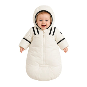 An infant resting comfortably in the Pramie black snow suit during a winter walk.