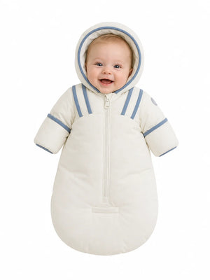 An infant resting comfortably in the Pramie blue snow suit during a winter walk.
