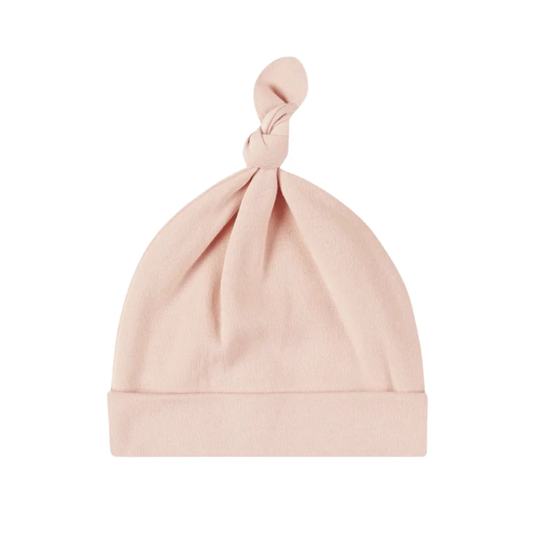 A front view of the Quincy Mae dusty rose bamboo knotted newborn baby hat.