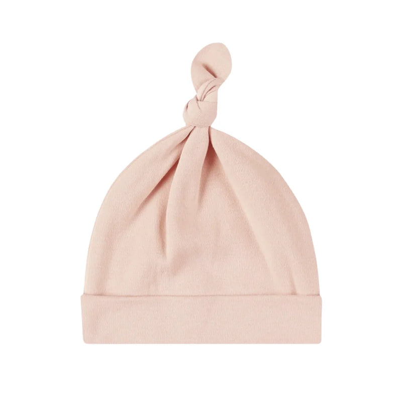 A front view of the Quincy Mae dusty rose bamboo knotted newborn baby hat.