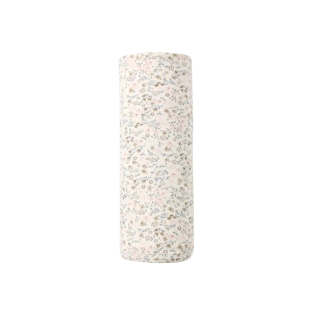 A neatly folded stack of the Quincy Mae botanical print bamboo swaddle.