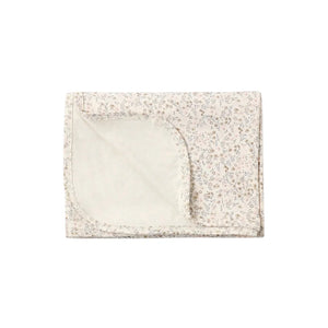 A flat lay view of the Quincy Mae bloom floral bamboo baby swaddle blanket.