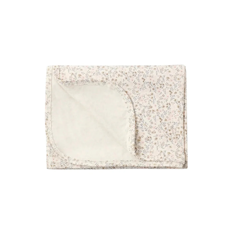 A flat lay view of the Quincy Mae bloom floral bamboo baby swaddle blanket.