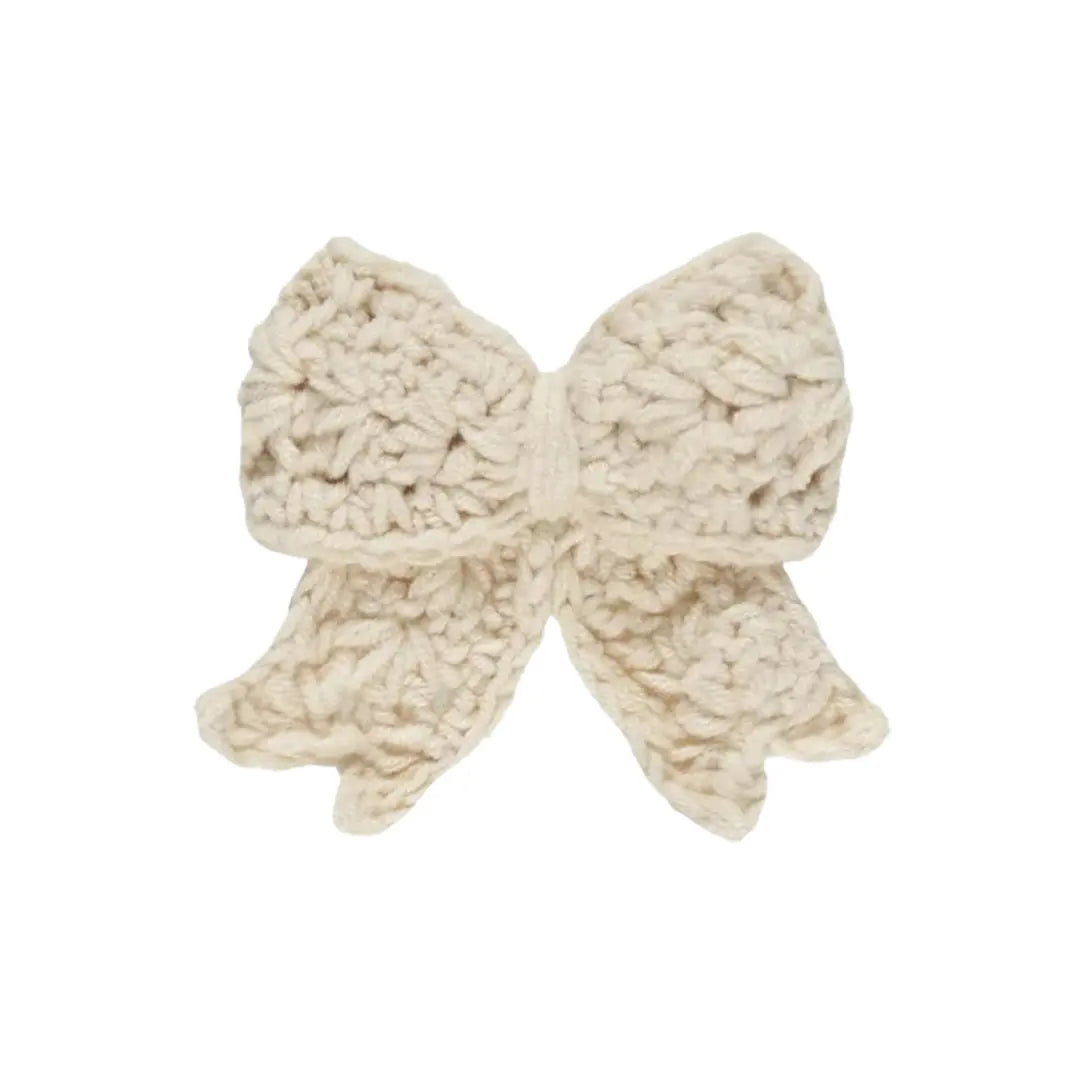 A flat-lay view of the Quincy Mae crochet hair bow in natural.