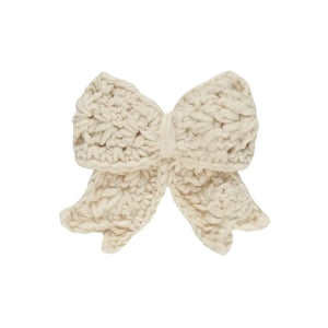 A flat-lay view of the Quincy Mae crochet hair bow in natural.