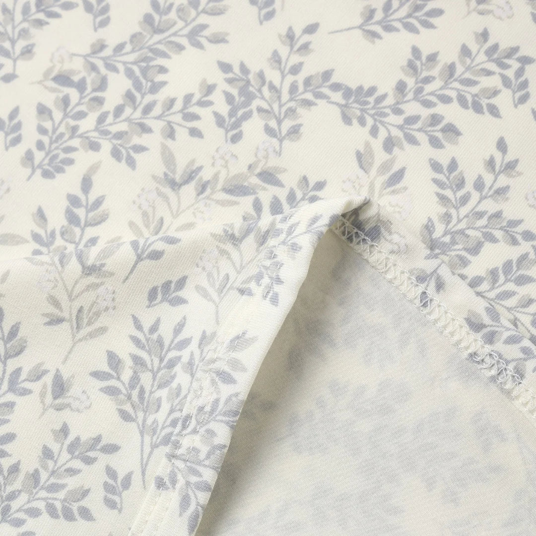 A high-resolution close-up of the silky bamboo textile texture and floral print.