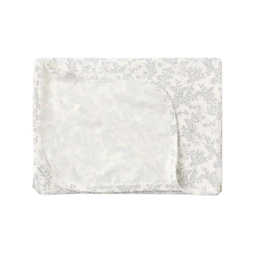 A flat lay view of the Quincy Mae cloud floral bamboo baby swaddle blanket.
