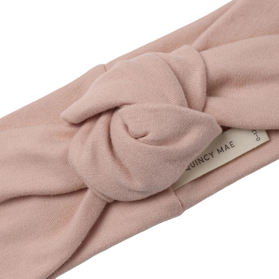 A high-resolution close-up of the soft organic cotton ribbed texture and top knot.