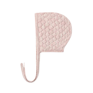 A front view of the Quincy Mae dusty rose speckle knit bonnet with chin ties.
