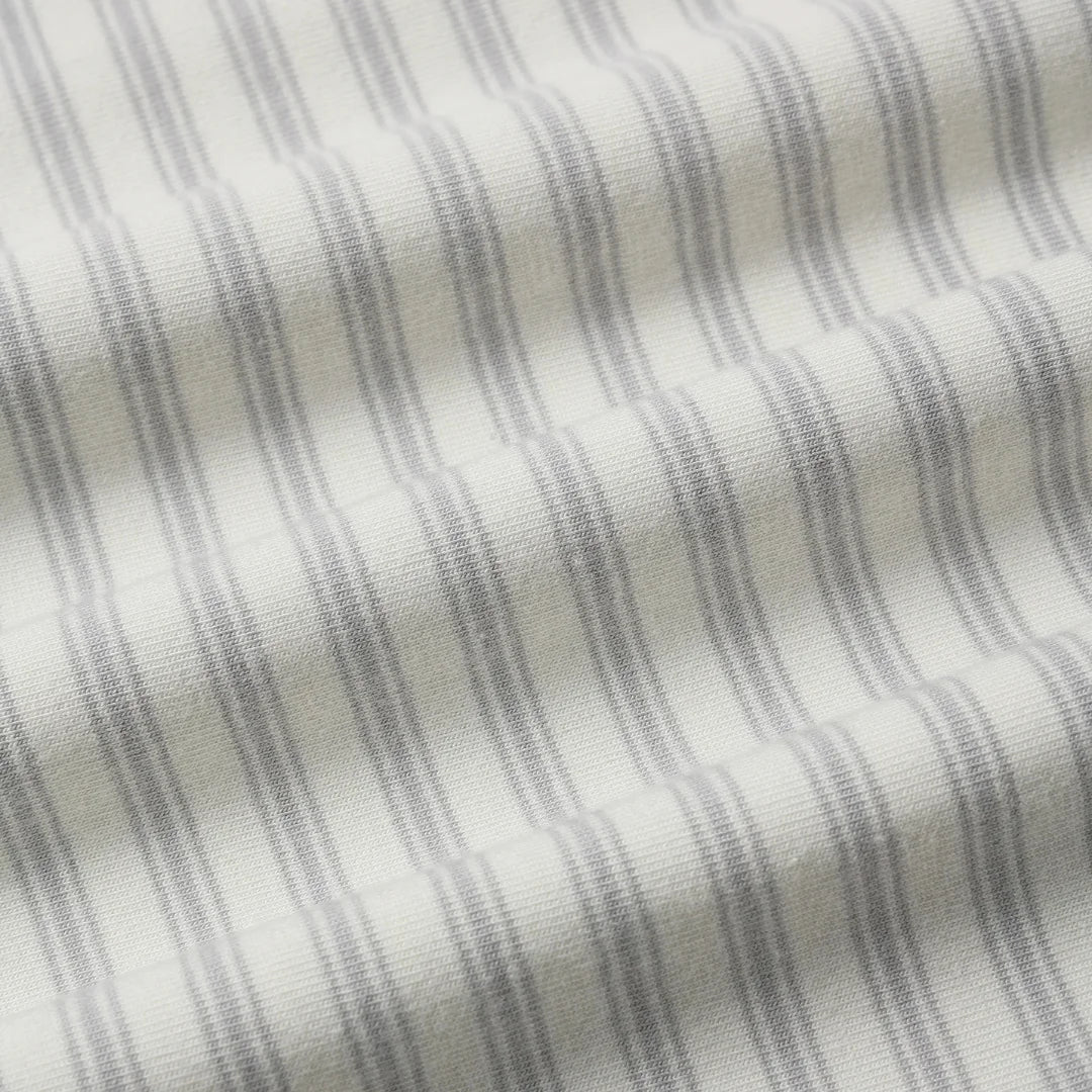 A high-resolution close-up of the breathable organic cotton texture and stripe pattern.