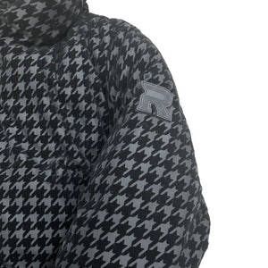 A high-resolution close-up of the black and white houndstooth fabric weave and buttons.
