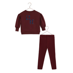 A vibrant cranberry red RetroKid Arden two-piece baby outfit made from smooth, stretchy scuba fabric back side