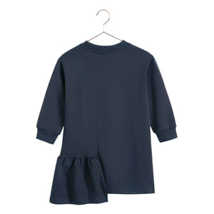 The back of the indigo blue Arden ruffle dress for girls by RetroKid, displaying its clean and simple rear profile.