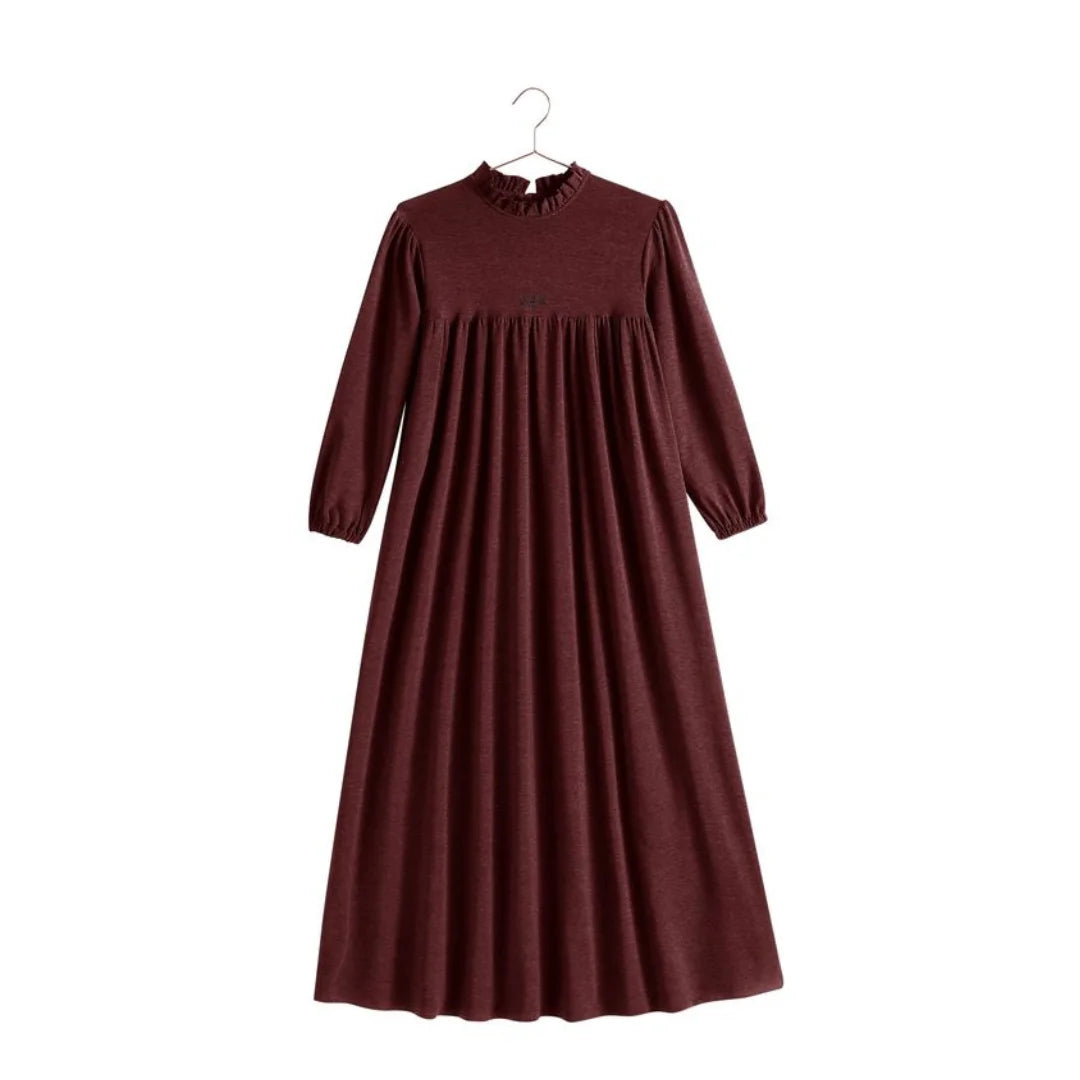 A profile view of the RetroKid girls sweater dress in burgundy, highlighting the relaxed, comfortable drape.