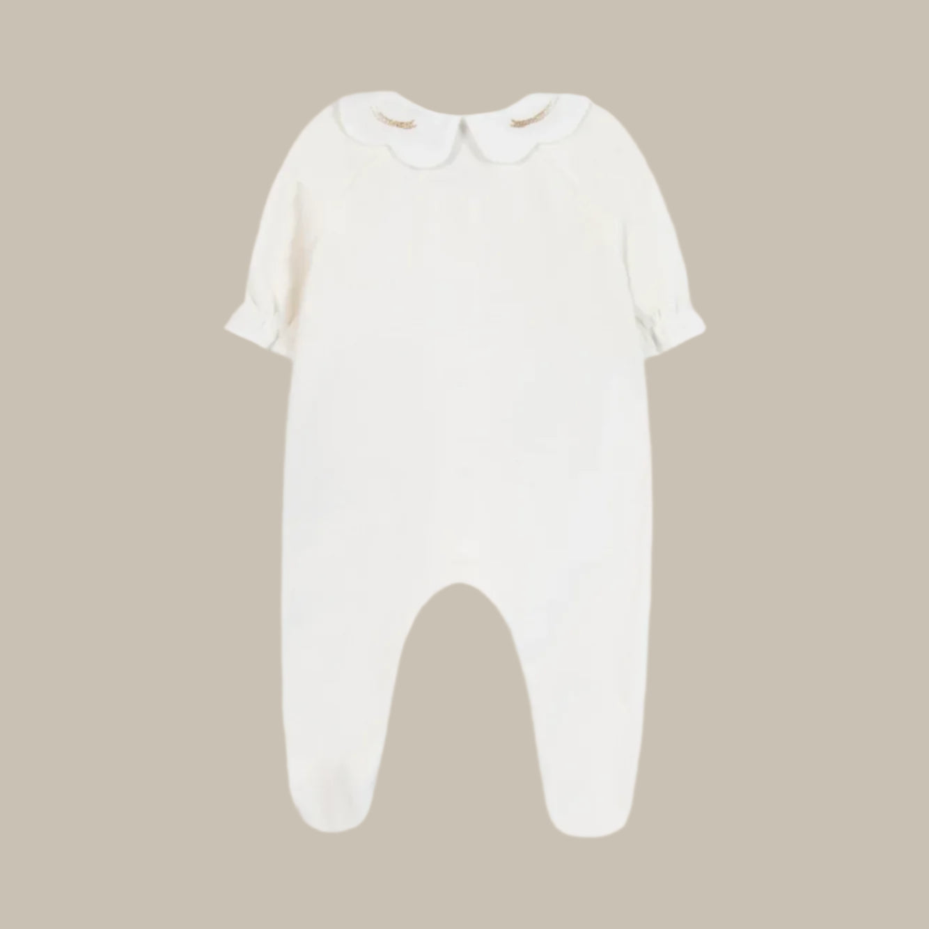 White baby onesie on a beige background