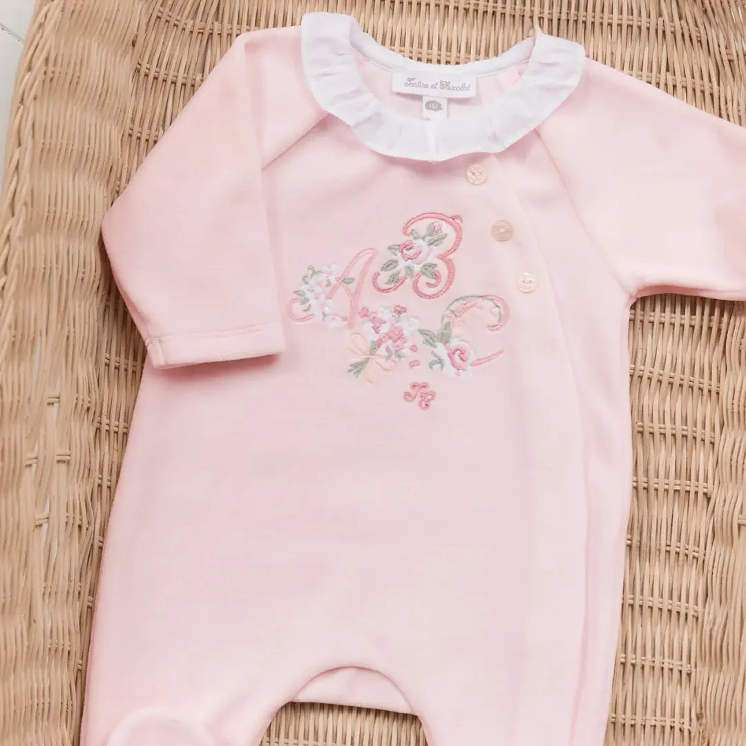 A sophisticated pair of white Tartine et Chocolat pajamas featuring a scalloped embroidered collar and high-end cotton texture.