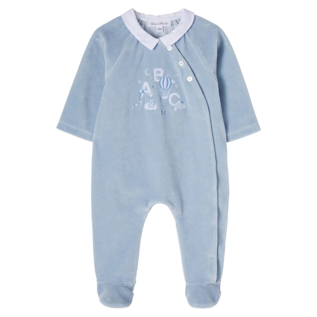 Blue baby onesie with white collar and ABC design on a white background