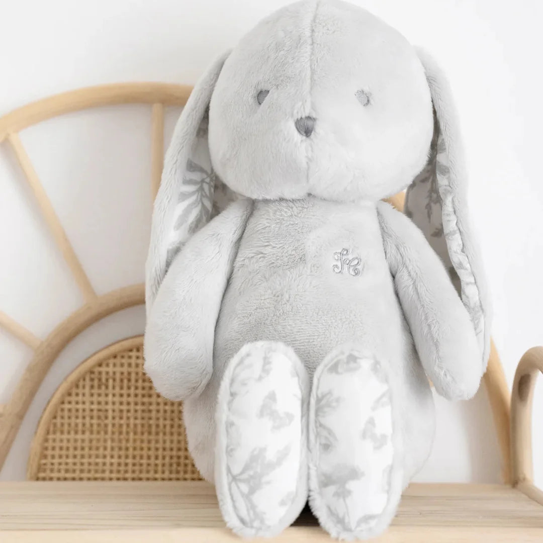 Close-up highlighting the fine grey toile de Jouy fabric pattern on the bunny's inner ear.