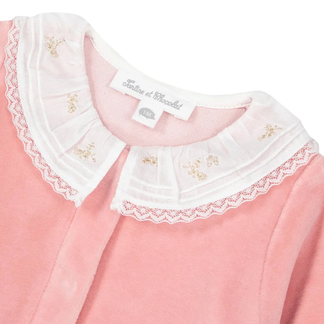 A high-resolution close-up of the ultra-soft cotton fabric texture and velvet collar trim.