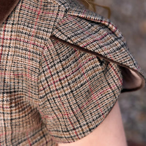 A high-resolution close-up of the velvet fabric texture, star details, and puffed sleeves.