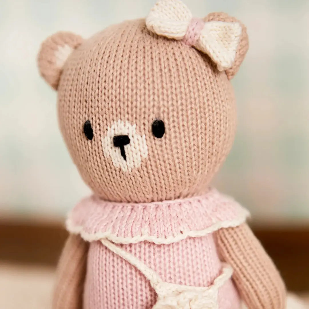 A high-resolution close-up of the embroidered features and soft fabric texture.