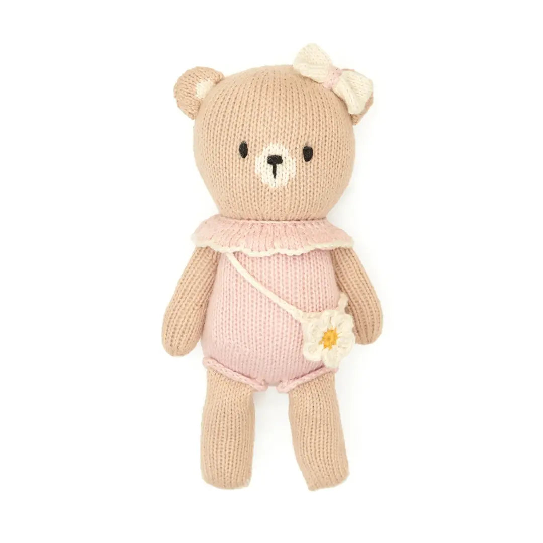 A flat-lay view of the Tuntun baby bear with purse in pink 8 inches.