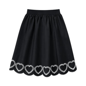 A front view of the We the Kids black scalloped heart children's skirt.
